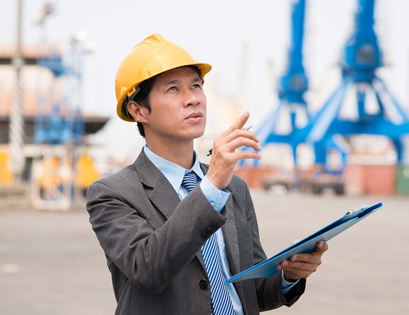 RFP Process - An Image of a man reviewing a clipboard on a construction site